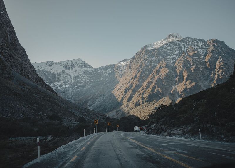 Alpine highway winding toward snow-capped mountains at Arthur's Pass, South Island New Zealand