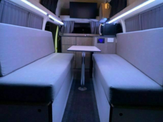 Foldout dining table and seating inside the campervan