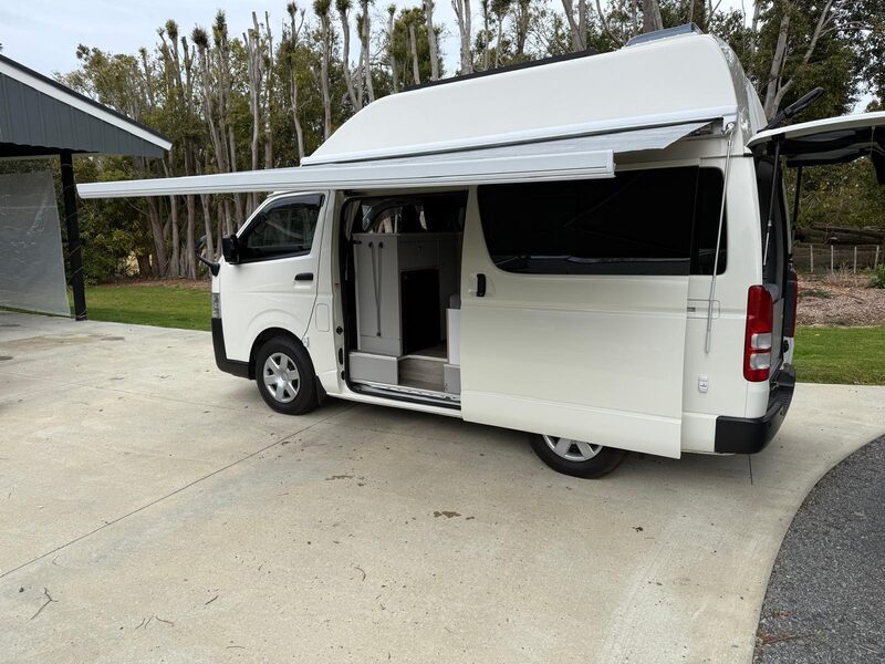 Side view of Harriet with the 3.5 metre awning wound out and the sliding door open