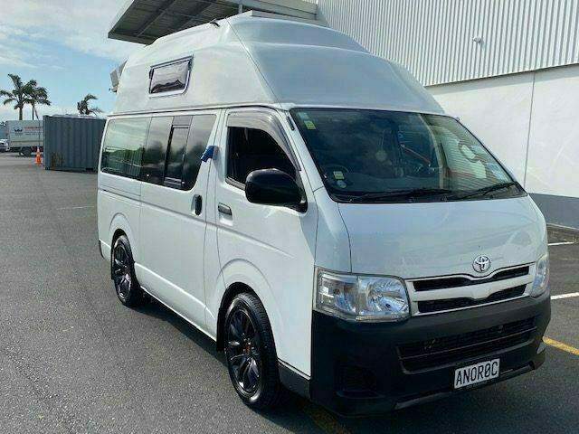 White high-roof Toyota Hiace campervan for hire, parked in Christchurch