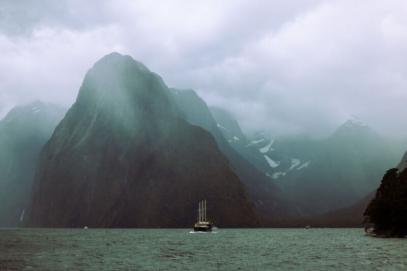 Mist rising over Milford Sound and Mitre Peak in Fiordland, South Island New Zealand
